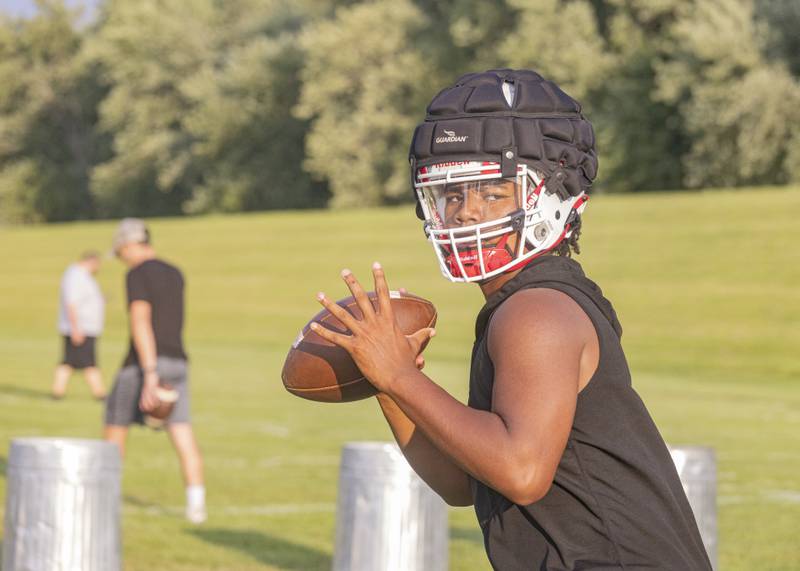 Ottawa quarterback Colby Mortenson looks downfield during the Pirates' first official practice of the season Aug. 7, 2023.