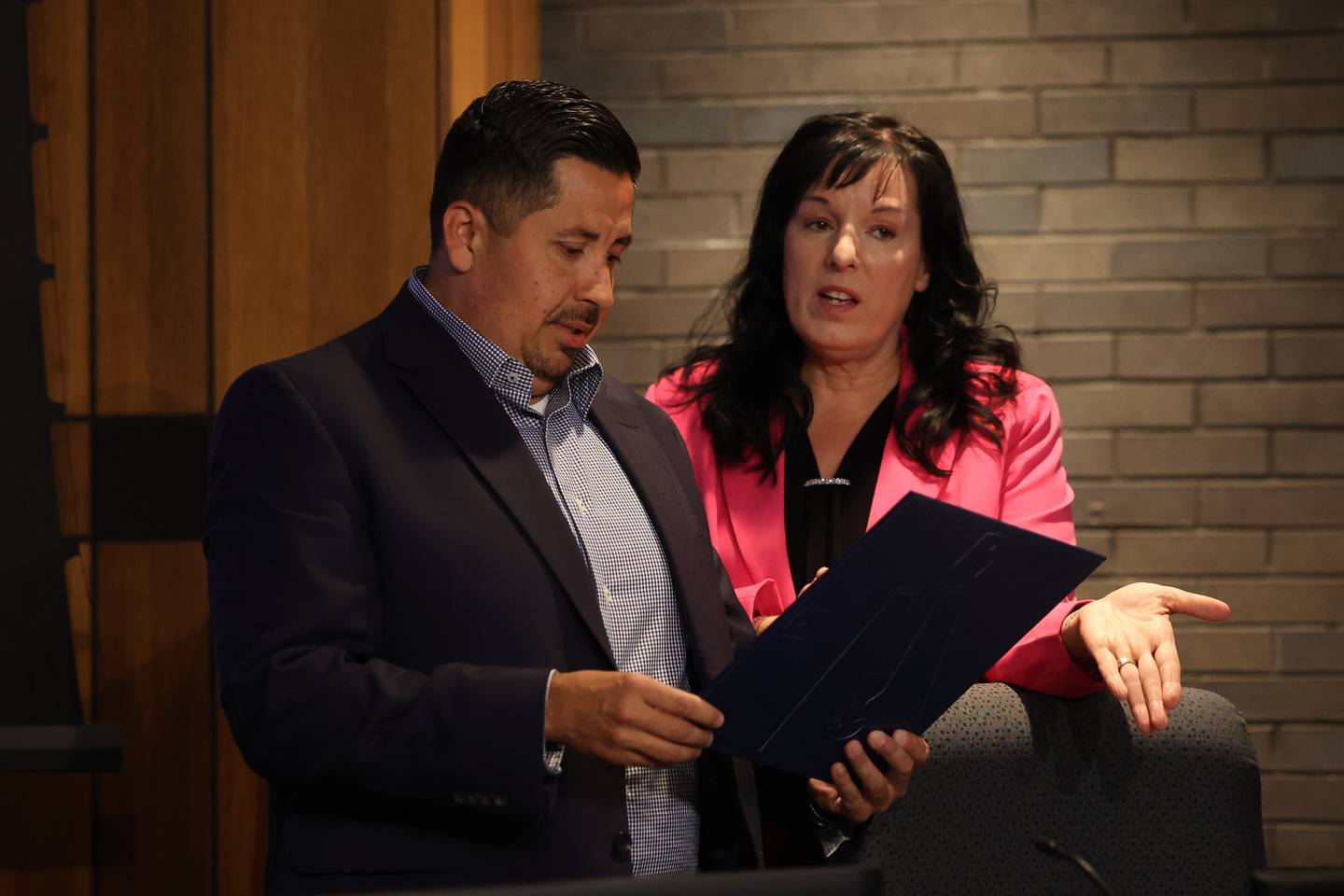 Joliet City Council members Cesar Cardenas and Suzanna Ibarra look over a proclamation before the the start of the Joliet City Council meeting on Tuesday, July 18th, 2023.