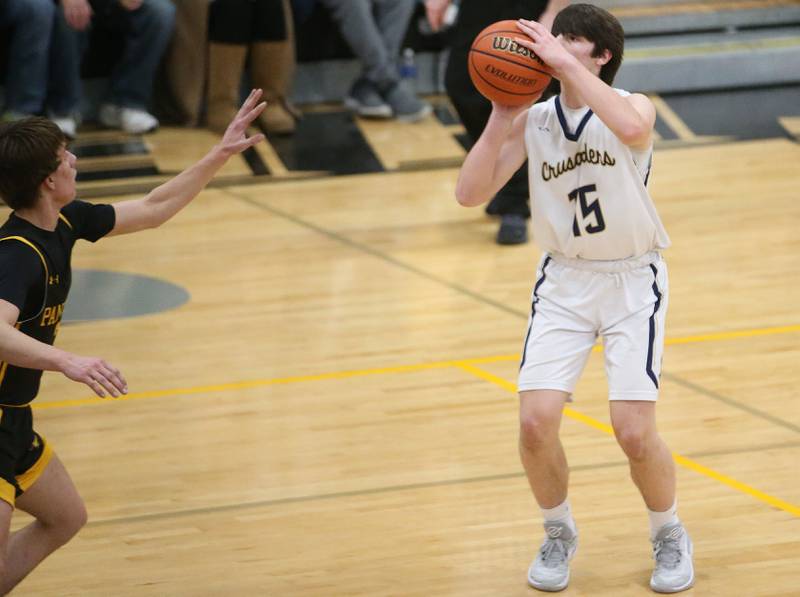 Marquette's Alec Novotney shoots a jump shot over Putnam County's Bryce Smith during the Tri-County Conference Tournament on Tuesday, Jan. 23, 2024 at Putnam County High School.
