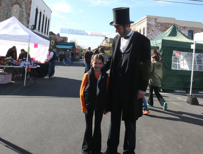 An Abrahama Lincoln impersonator poses for a photo with Alble Ryan of Standard during the 54th annual Burgoo on Sunday, Oct. 13, 2024 downtown Utica.