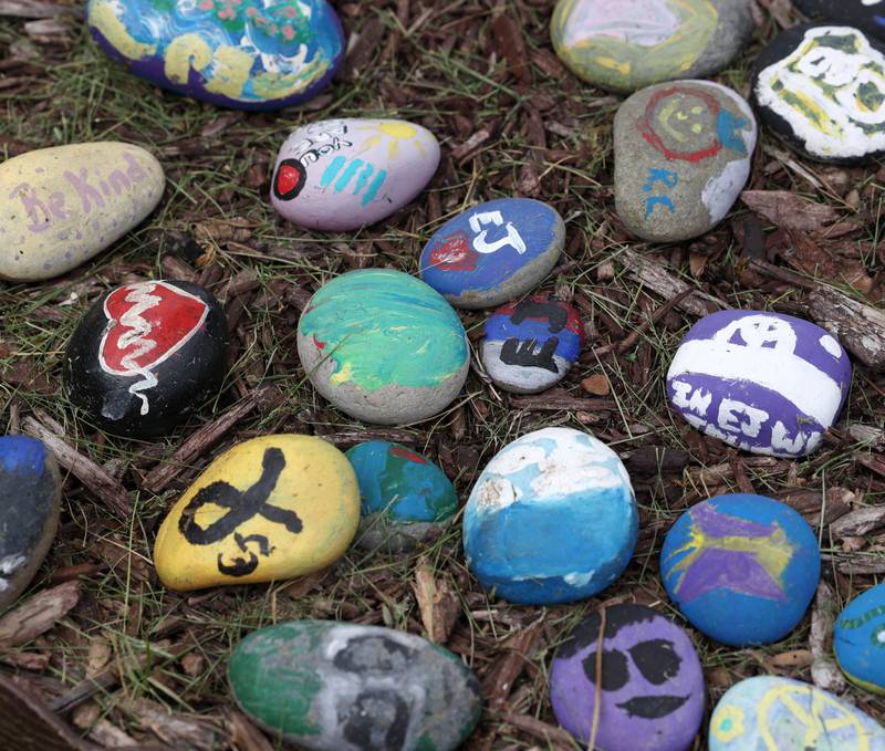 Some of the rocks in the rock garden Monday, May 12, 2025, dedicated to the memory of Ezra Hill Jr. at Tyler Elementary School. Hill was murdered in 2019 in Harvey, and the Fifth Annual Ezra Hill Jr. Memorial Rock Painting event will be held on June 7 at the school in DeKalb.