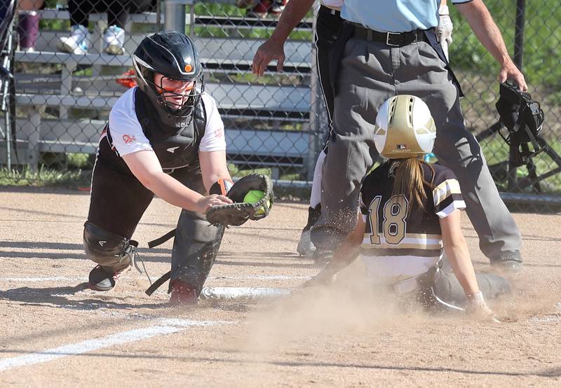 Sycamore's Addison McLaughlin slides safely into home with Sycamore’s first run of the game as Freeport's Quinn Krzeminski takes the throw during their Class 3A regional championship game Friday, May 26, 2023, at Sycamore High School.