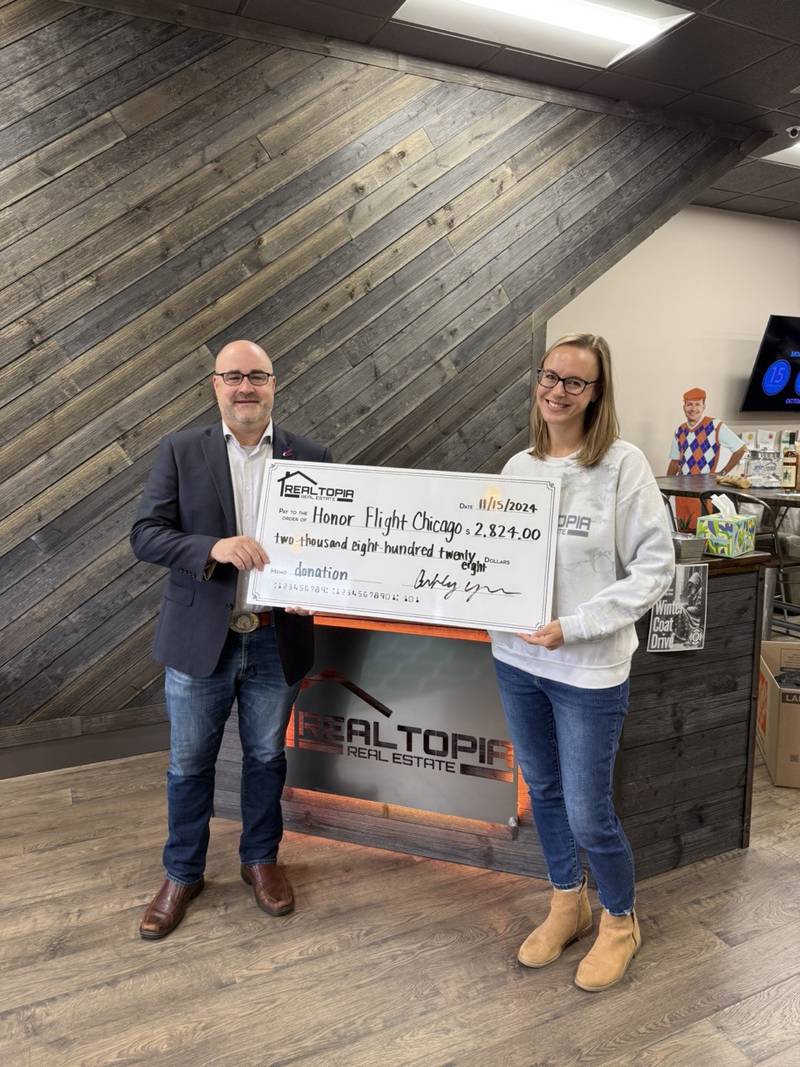 Realtopia Real Estate, Inc., a boutique real estate brokerage in downtown Lockport, raised more than $2,800 to benefit Honor Flight Chicago during a campaign to generate more listings for the company. The company’s Designated Managing Broker and Founder, Ashley York (right). is pictured with Doug Meffley, co-director, Honor Flight Chicago.