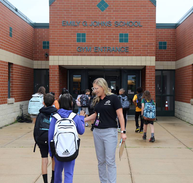 Assistant Principal, Dr. Leslie Kressin, welcomes students on the first day of school at Emily G. Johns School in Plano on Thursday, Aug. 17, 2023.