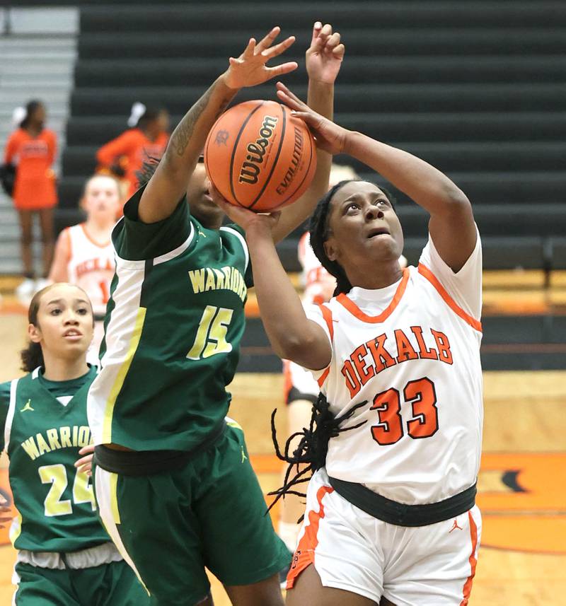 DeKalb's Cayla Evans tries to get up a shot in front of Waubonsie Valley's Taylor Curry during their game Thursday, Dec. 15, 2022, at DeKalb High School.