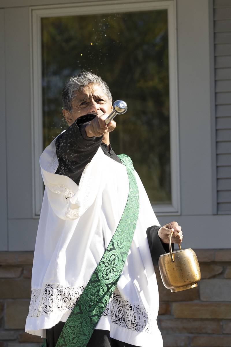 Deacon Armando Regalado blesses the newest OSF Saint Katharine clinic in Sterling with holy water Wednesday, Oct. 8, 2025.