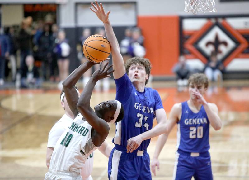 Glenbard West's Josh Abushanab tries to get a shot past Geneva’s Andrew Conley during the Class 4A St. Charles East Sectional final on Friday, March 7, 2025 in St. Charles.