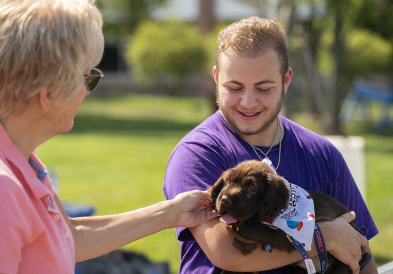 "She's a sweetheart." Says Casey Golding, of Border Tails Rescue, as Sandy Pierri, of Carol Stream, pets Topeka, a mix between a Chinese Shar Pei and Cocker Spaniel who was up for adoption during the 7th Annual VetBros Charity Dog Show on Sunday, August 4th, 2024 at the Ross Ferraro Town Center in Carol Stream. The event featured awards, vendors, a dog agility course and a doggy water play area. All proceeds benefited the VetBros Pet Education Charitable Fund which helps community pet owners in need.