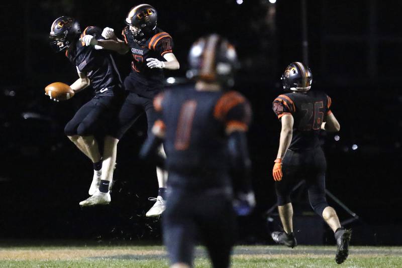 Crystal Lake Central players celebrate around Jason Penza, left, after his touchdown against Deerfield during their playoff football game at Crystal Lake Central High School on Friday, Nov. 5, 2021.
