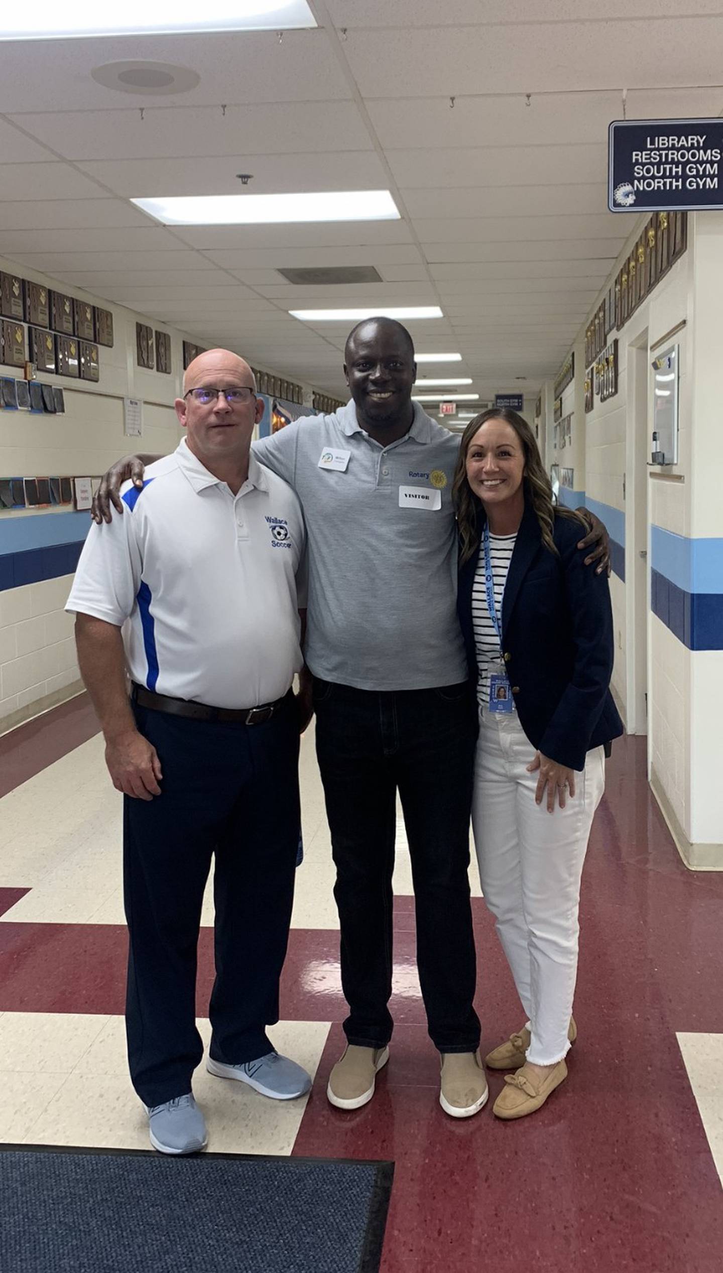 Superintendent Toby Coates and Principal Melanie Hart took a moment to pose for a photo with Milton Tusingwire following the presentation at Wallace Grade School in Ottawa.