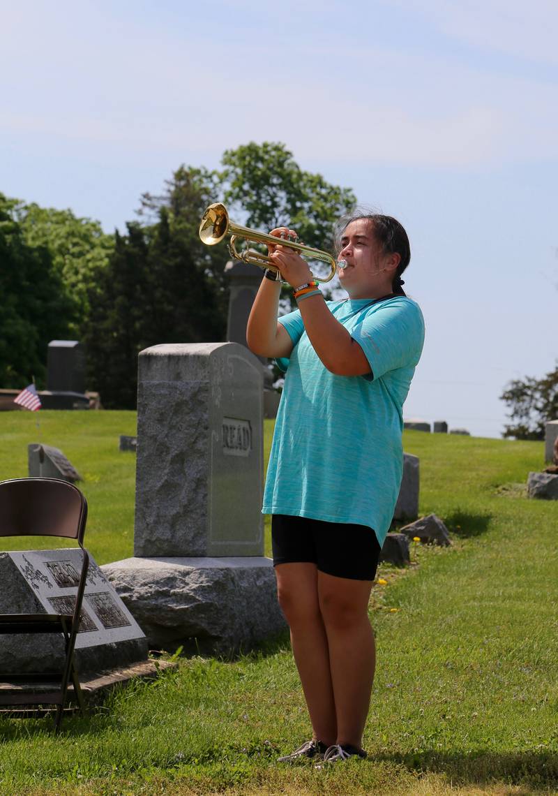 Clara Paulson plays Taps at the Memorial Day Ceremony at Blackberry Cemetery in Elburn on Monday, May 30, 2022.