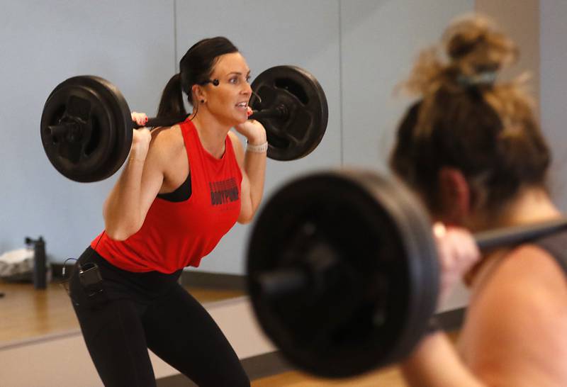 Becky Moore, a fitness coordinator at the McHenry Recreation Center, leads a Les Mills Body Pump and Core class Thursday, Dec. 22, 2022, at the center in McHenry.