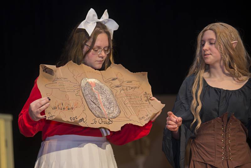 Agnes checks out a map while playing a campaign of Dungeons and Dragons in the play “She Kills Monsters.”