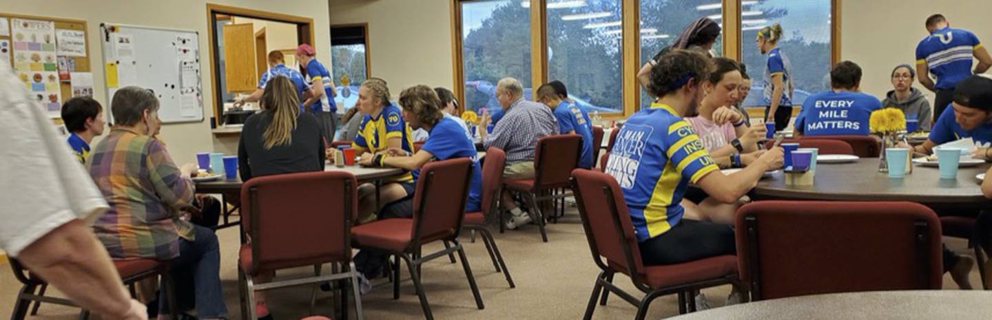 Pictured: Ulman Foundation's 4K for Cancer ride participants sitting in St. Paul's Parish Hall in 2019