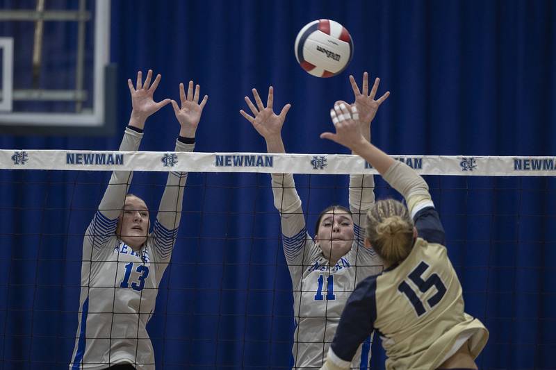 Newman’s Kennedi Shippert (left) and Isabelle Lanning go up for a block against Mercer County’s Rylee Bigham Wednesday, Sept. 24, 2025.