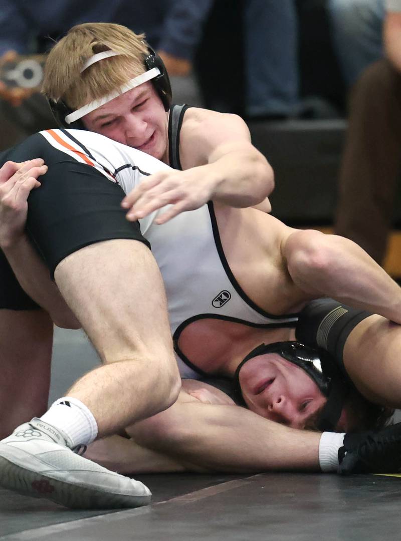Sycamore’s Cole Kleiser (top) wrestles Kaneland’s Wyatt Yakle at 150 pounds Thursday, Jan. 9, 2025, at Sycamore High School.