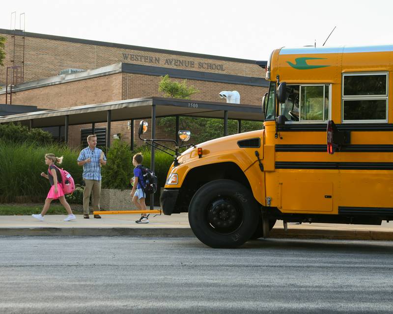 Western Avenue Elementary School principal Casey O’Connell welcomes students getting off the bus for the first day of school on Thursday Aug. 21, 2025, in Geneva.