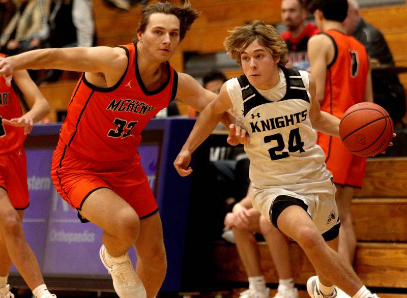McHenry’s Adam Bronowicki, left, defends as Kaneland’s Luke Reinert, right, moves the ball in Hoops for Healing basketball tournament championship game action at Woodstock Wednesday.