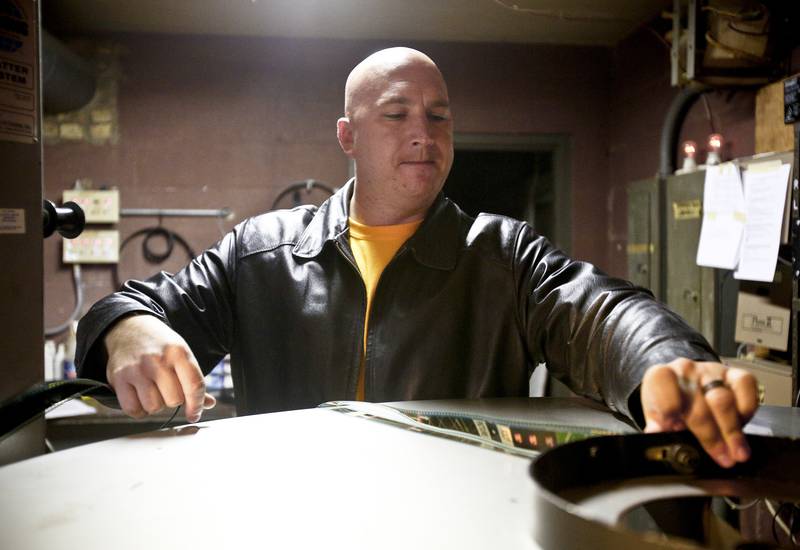 Scott Dehn, owner of the McHenry Outdoor Theater, loads a movie film onto a reel before a show Sept. 21, 2012, in McHenry. The theater was one of five drive-ins nationwide that one a digital projector that Honda was giving away through the "Project Drive-In" contest.