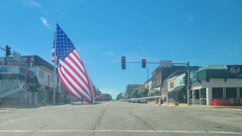 60-by-30 foot American flag was set up over Main Street in Princeton on Friday morning ahead of the city’s first summer concert, but the flag poles snapped and the pole supporting the flag landed on the ground. It is shown here after the pole had snapped.