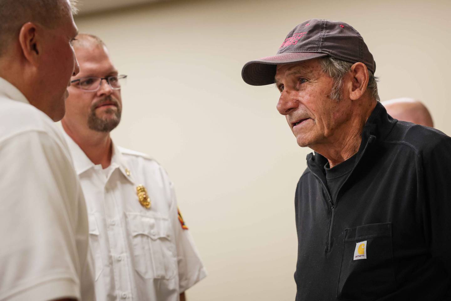 Bob Dodson, right, was trapped underneath a tractor on Sunday, July 20, 2025. Family, neighbors and firefighters were recognized for their help saving his life on Tuesday, Oct. 14, 2025, at the Harvard Fire Protection Board of Trustees meeting.