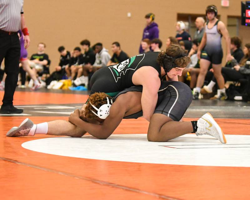 Tyler Curtis of Sycamore, bottom, keeps a hold of York wrestler Matt Barton of York during the 182 weight class on Thursday’s Dec. 29th portion of the Don Flavin tournament held at DeKalb High School.