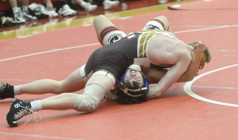 Ottawa’s Olie Kearfott works to escape from under Morris’ Ian Wills in the 165-pound match Wednesday at Ottawa.