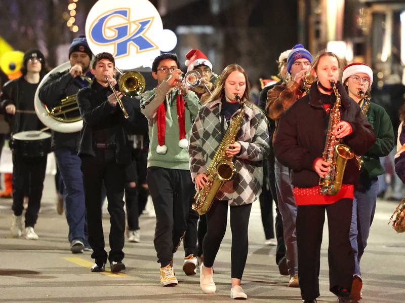 Members of the Genoa-Kingston marching band head through downtown in 21st Annual Jingle Bell Walking Parade Friday, Dec. 2, 2022, during Celebrate the Season hosted by the Genoa Area Chamber of Commerce.