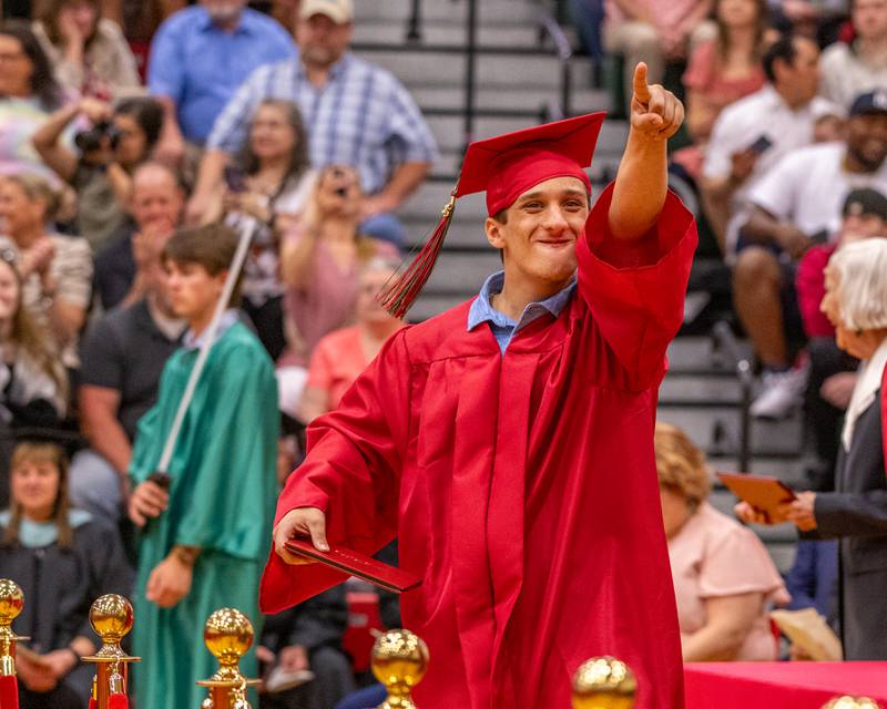Miles Pangrcic acknowledges cheering friends in the audience after receiving his diploma at the LaSalle-Peru Township High School Class of 2025 commencement ceremony on Thursday, May 15, 2025 in Sellett Gymnasium.