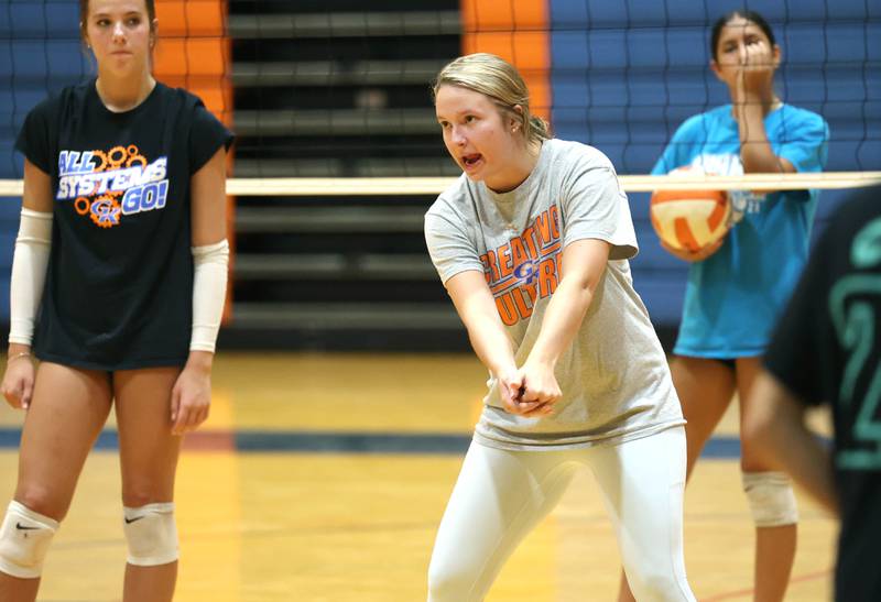 New Genoa-Kingston head volleyball coach Taylor Spellman demonstrates a bumping technique during practice Thursday, Aug. 1, 2024, at the school in Genoa.