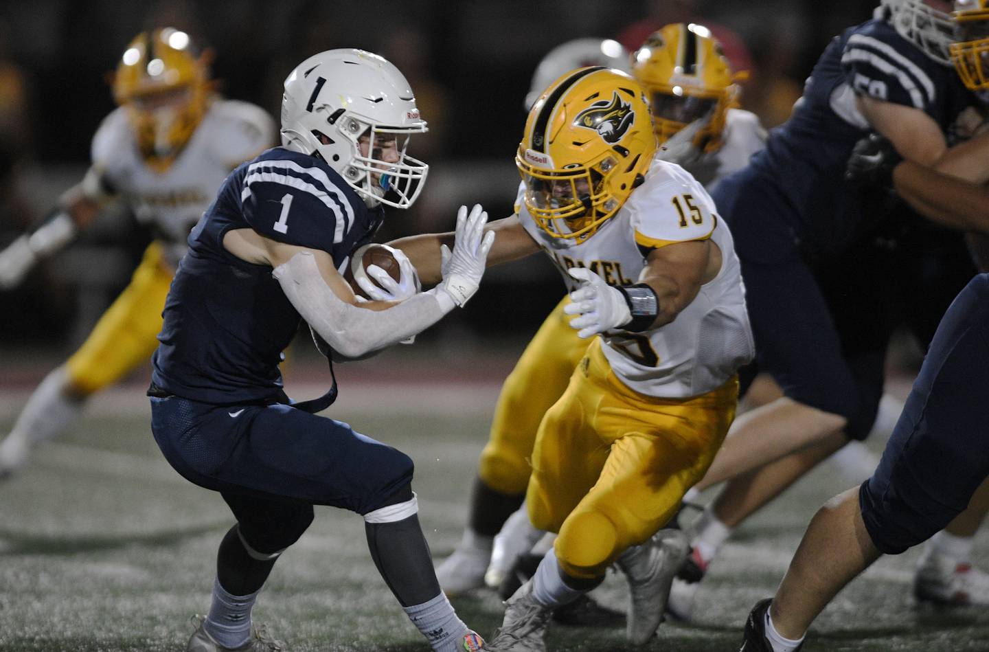 St. Viator’s Jake VanBooven tries to get past Carmel’s Kyle Lynch in a football game in Arlington Heights on Friday, September 16, 2022.