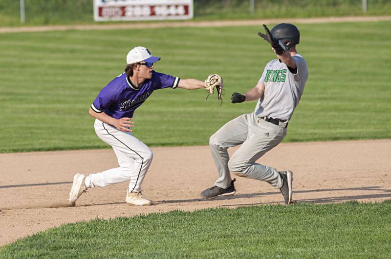 Dixon’s Bryce Feit tags out North Boone's Tyler Slater Thursday, May 12, 2022.