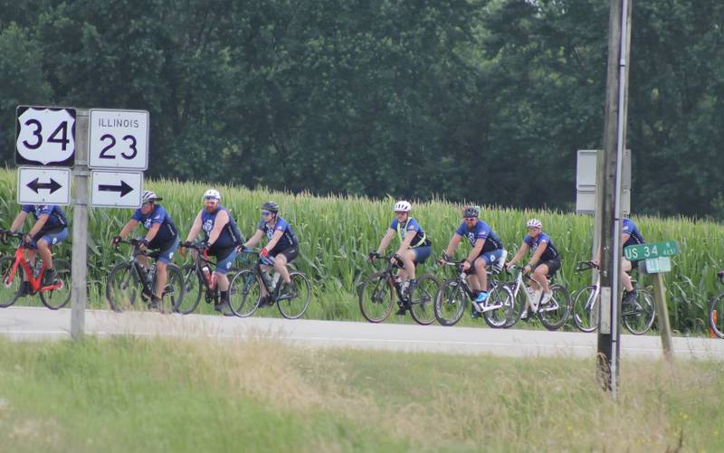 Cyclists participating in Cycle Across Illinois, a charity campaign to honor fallen police officers and raise funds for their families, head east on Illinois Route 34 toward Route 23 on their way to DeKalb on Saturday, July 12, 2025.