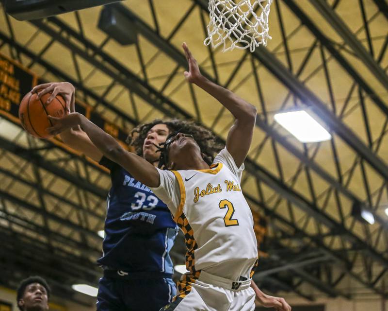 Plainfield South's Isaiah Robertson (33) blocks a shot by Joliet West's Elijah Wilson (2) during their basketball game between Plainfield South at Joliet West, Feb 2, 2026 in Joliet.