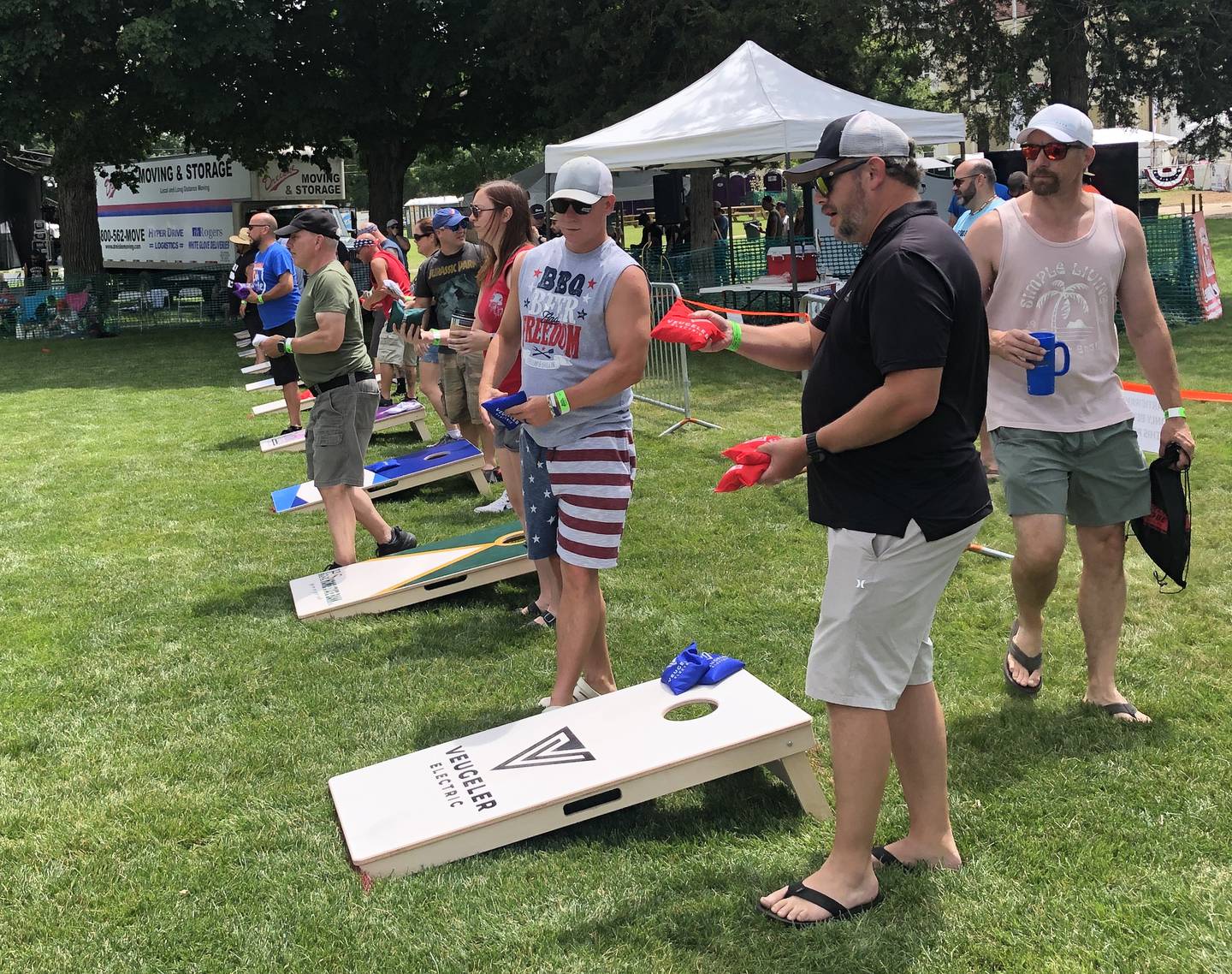 Team members warm up Saturday, July 6, 2024, for the Cornhole Tournament that is part of the annual Lakeside Festival at The Dole in Crystal Lake. The annual event's 1st Place team takes home $500.