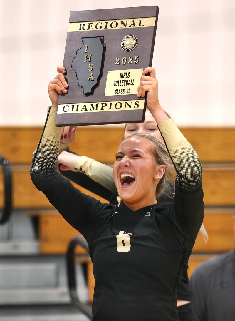 Sycamore's Lana Walker hoists the regional champion plaque after their Class 3A regional championship win over Dixon Thursday, Oct. 30, 2025, in Rochelle.