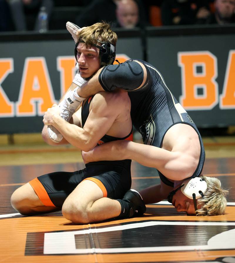 DeKalb’s Sean Kolkebeck and Sycamore’s Cooper Bode get tangled up Friday, Jan. 17, 2025, during their 175 pound match at DeKalb High School.