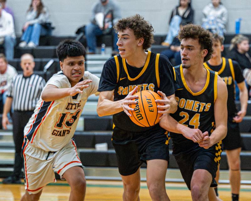 Vinny Bollino (32) of Reed-Custer grabs loose ball as Enrique 'Kike' Lopez (13) of DePue trails during game in the Shipyard Showdown on Tuesday, December 23, 2025 at Seneca High School in Seneca.