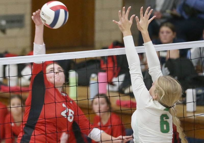 Henry-Senachwine's Brooklyn Thompson spikes the ball past Seneca's Graysen Provance during the Tri-County Conference Championship game on Thursday, Oct. 17, 2024 in Bader Gym at Marquette High School.