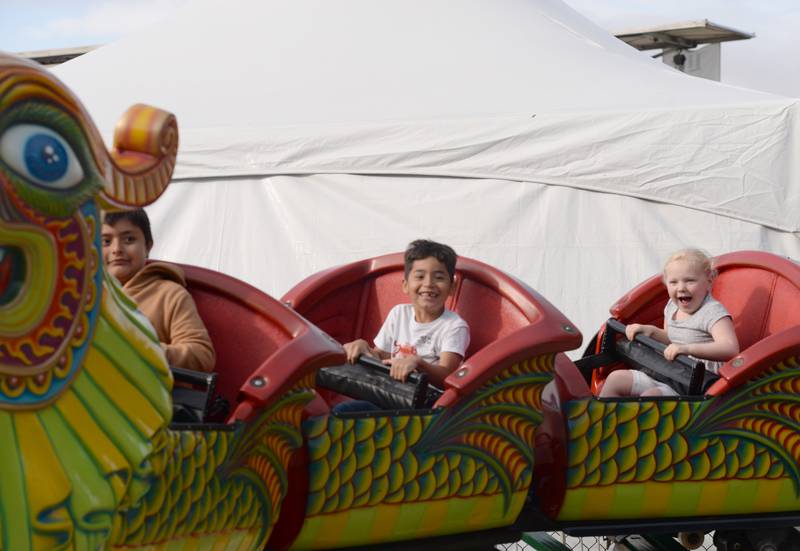 Children including (left-right) Ethan Hernandez of Garfield Rich, Damion Arciniegaof Brookfield and Brooklyn Quirk of La Grange Park enjoy riding theDragon while attending the  LaGrange Endless SummerFest Sunday Aug 6, 2023.