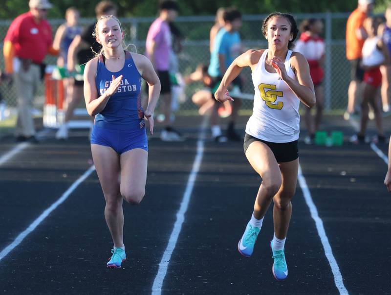 Genoa-Kingston’s Haley Oranger (left) and Carmel’s Maliyah Mays run the 100 meters Friday, May 15, 2026, during the Class 2A girls track sectional at Genoa-Kingston High School.