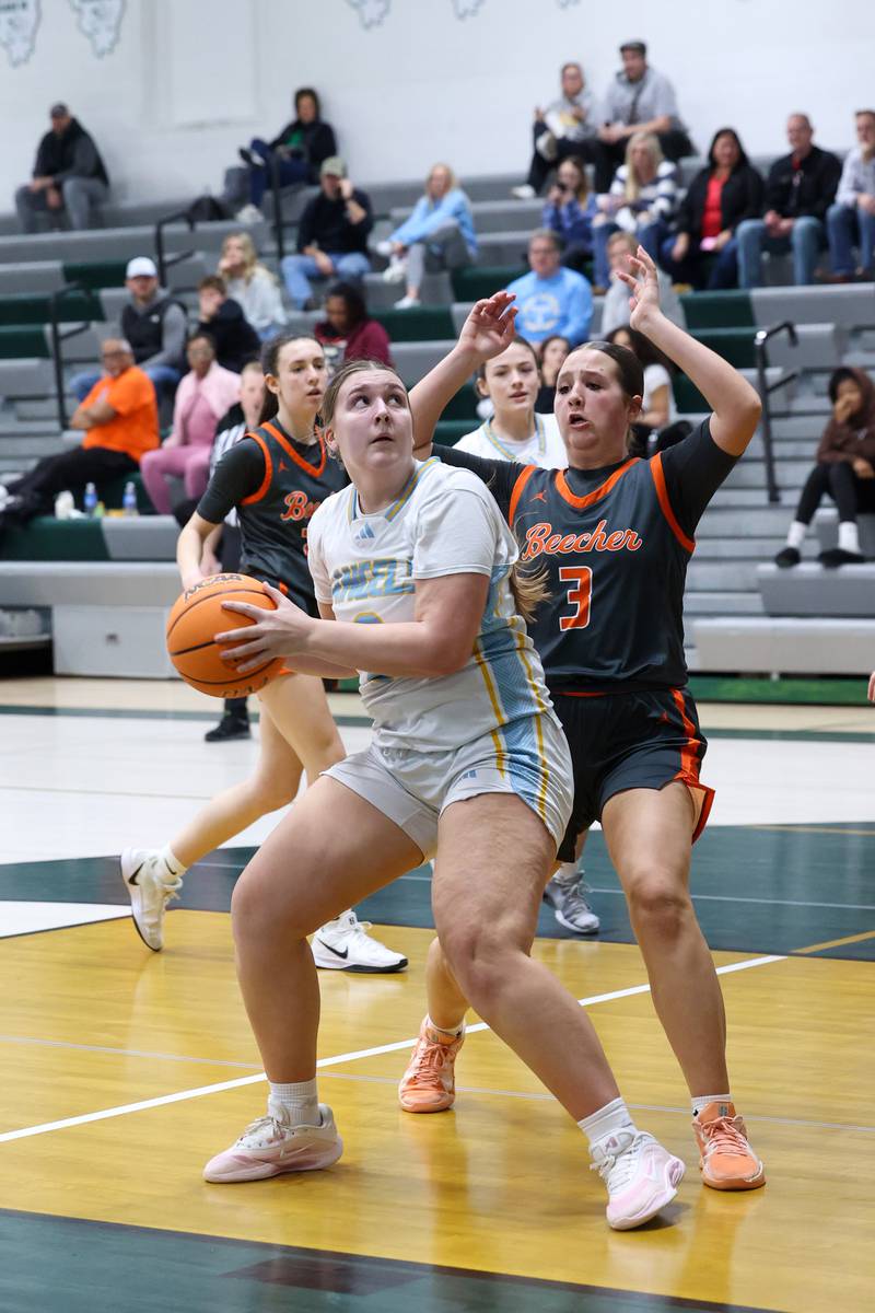 Joliet Catholic's Lindsey Blabas looks to shoot under pressure from Beecher's Alexandra Johnson during Joliet Catholic's 72-28 victory over Beecher in the IHSA Class 2A Bishop McNamara Regional semifinals on Monday, Feb. 16, 2026.