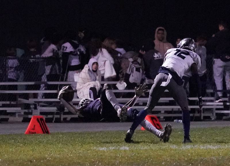 Oswego’s Jeremiah Cain (1) makes a one handed grab of a tipped ball against Oswego East's Nigel Grisby (12) during a football game at Oswego High School on Friday, Oct. 20, 2023.