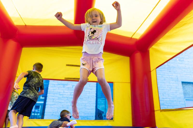 Six-year-old Lockport resident Abby Johnson has fun in a bounce house during Fire Fest in Lockport on August 10, 2024.