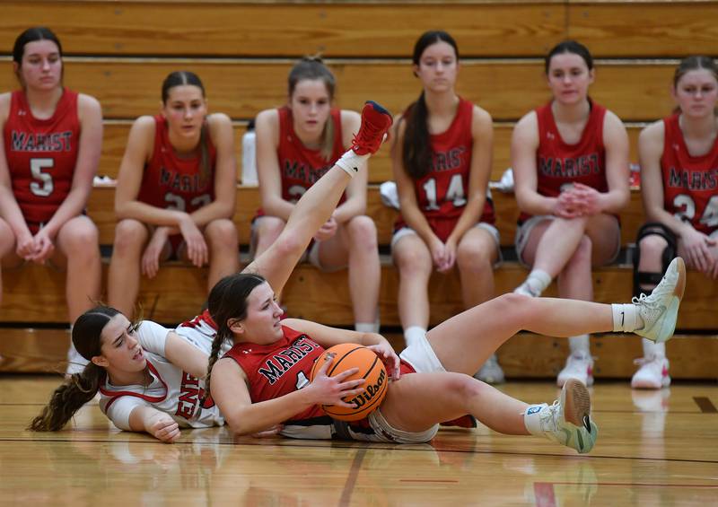 Benet’s Ava Mersinger (left) and Marist’s Grace Harmon end up on the floor after contact during a game on January 8, 2025 at Benet Academy in Lisle.