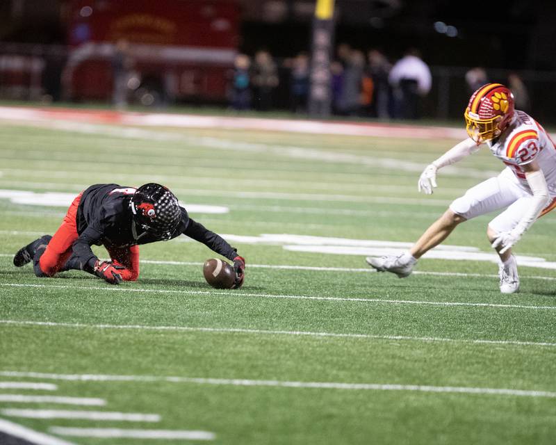 Glenbard East's Malachi Miller grabs the loose ball before Batavia's Andrew Colamatteo at the Class 7 A Second Round playoff game on Friday, Nov. 7,2025 in Lombard.