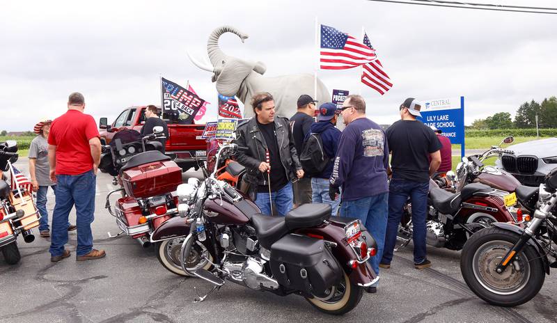 Supporters of President Trump gather on Sunday, Aug. 18, 2024 in Lily Lake before participating in a caravan to a rally in Woodstock.