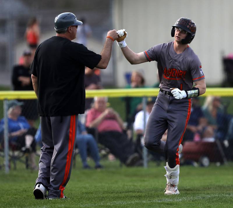 McHenry's Kaden Wasniewski high fives McHenry Head Coach Brian Rockweiler after he hit a two-run home run during a Fox Valley Conference baseball game against Crystal Lake South on Monday, April 13, 2026, at Crystal Lake South High School.