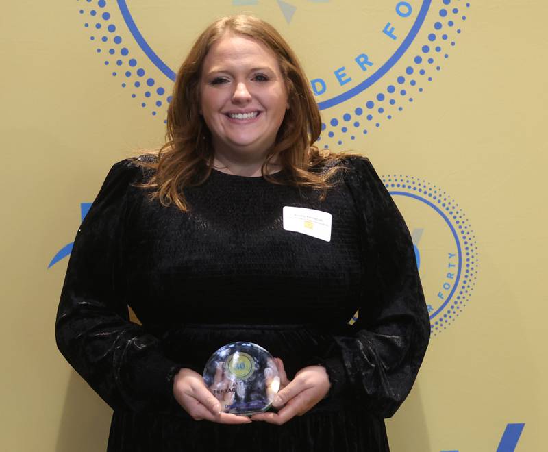 Alexis Ferracuti poses with her 40 Under Forty award during the Illinois Valley Chamber of Commerce Champions of Change Awards Night on Wednesday, May 6, 2026 at the Westclox Event Center in Peru.