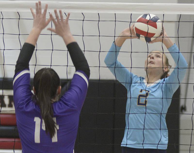 Marquette’s Anna Hjerpe sets tip the ball past Lexington’s Cori Pearce  during the 1st set Tuesday at the Woodland Sectional.